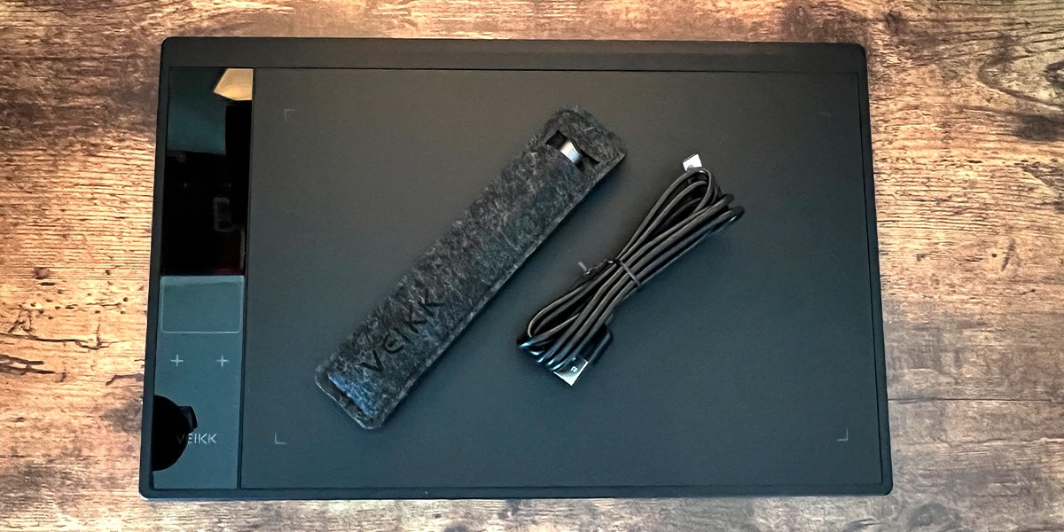 Veikk A30 V2 Drawing Tablet with accessories on wooden background Veikk A30 V2 Drawing Tablet with accessories on wooden background