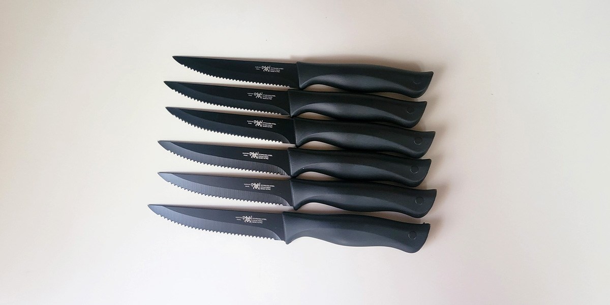 Six black Hunter.Dual Knife Set knives displayed on counter Six black Hunter.Dual Knife Set knives displayed on counter