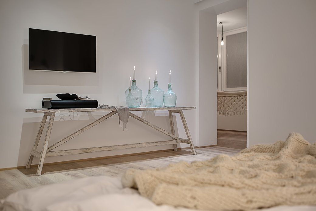 TV mounted on wall with sound bar mounted underneath