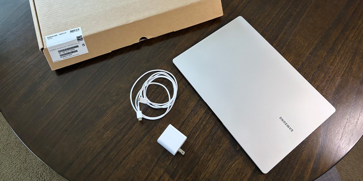 Laptop, power cord and product box on desk